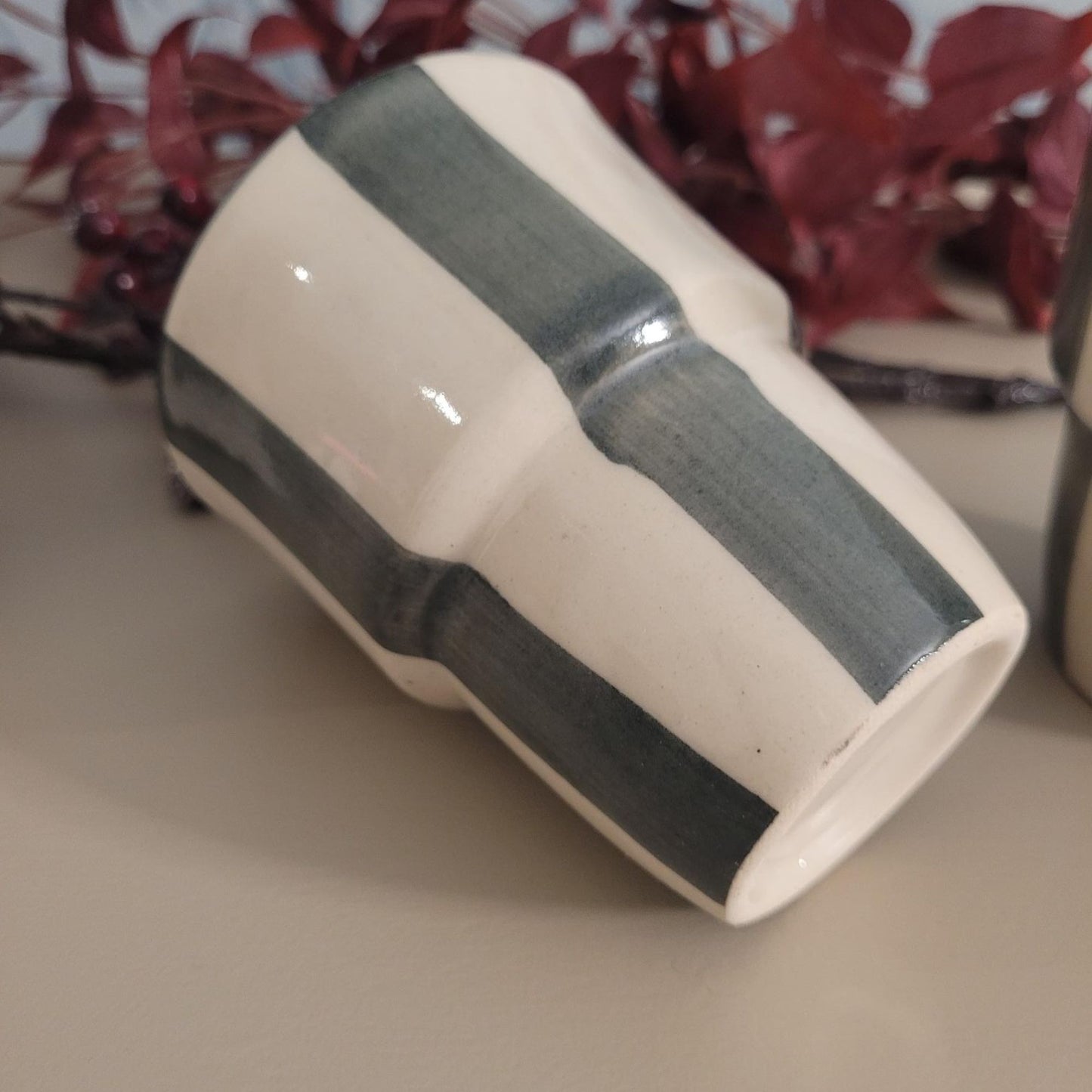 Stoneware handleless coffee beaker with green and cream Scandi stripes, 180ml.