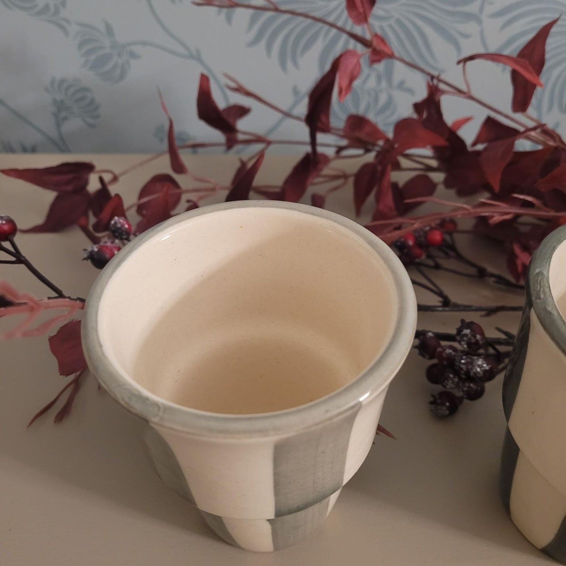 Stoneware handleless coffee beaker with green and cream Scandi stripes, 180ml.