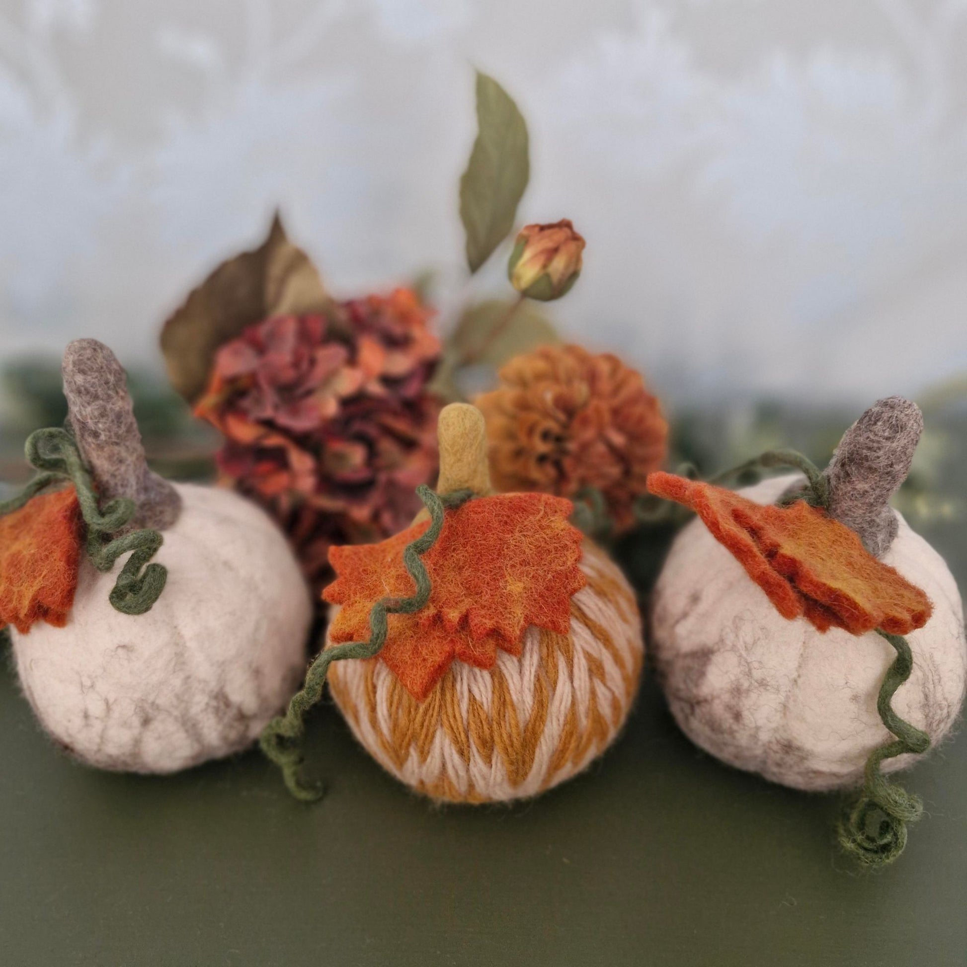 White and grey needle-felted wool pumpkin with leaf and upright stem, 11×11×15cm.