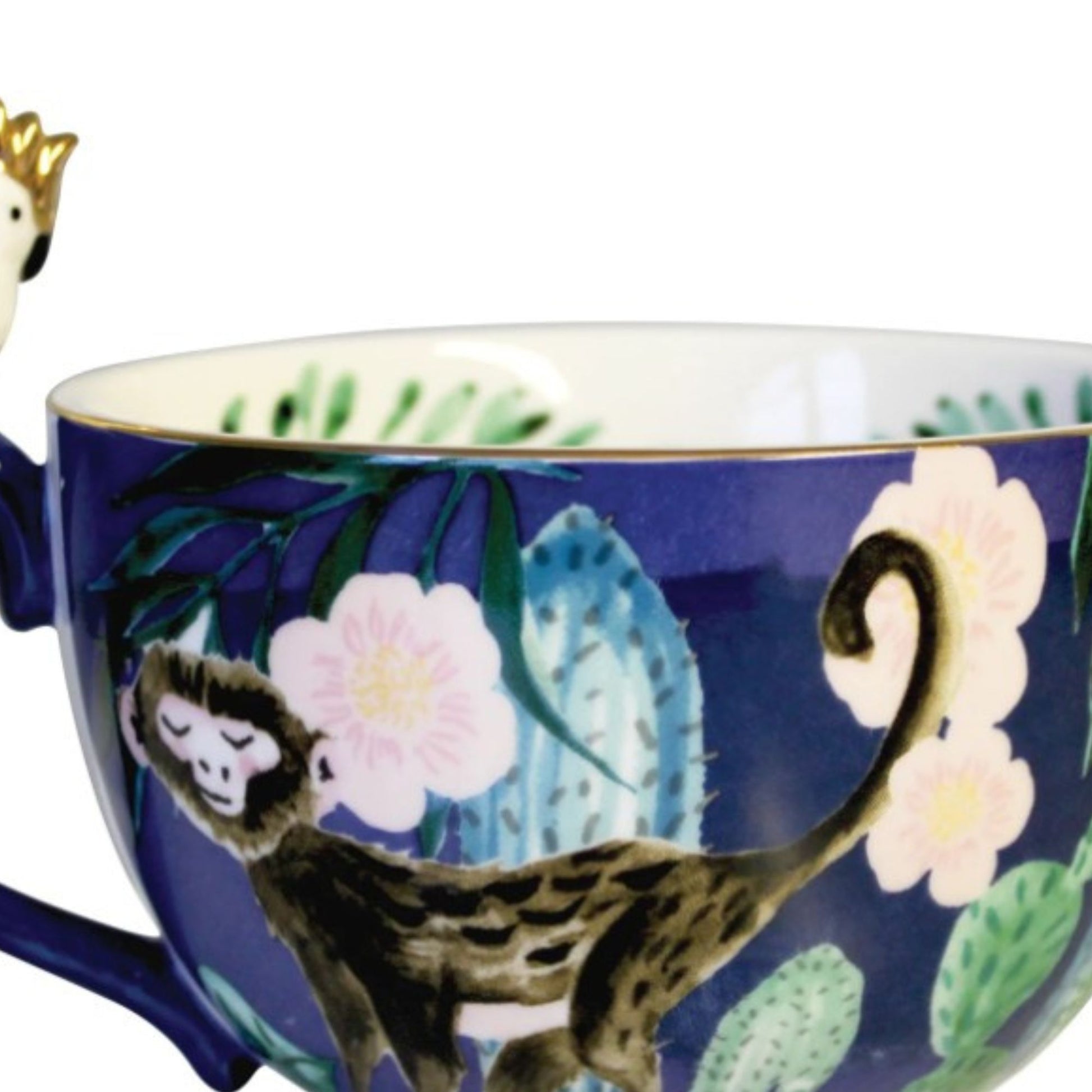 Frida Kahlo tropical porcelain mug with gold parakeet handle, gold signature and leaf print inside.