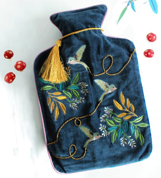 Dark blue velvet hot water bottle cover with embroidered swallows, gold stitching, pink piping and tassel.