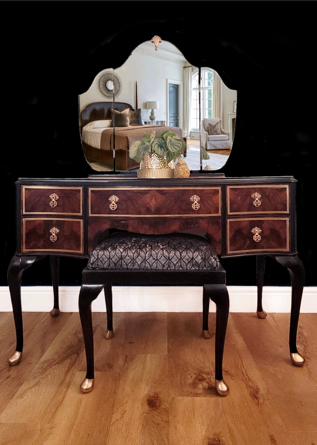 Hand-painted 1930s Art Deco dressing table with tri-fold mirror, featuring black and gold detailing, walnut veneer, and a reupholstered stool in patterned fabric. Perfect as a statement piece in a modern or vintage-inspired bedroom.