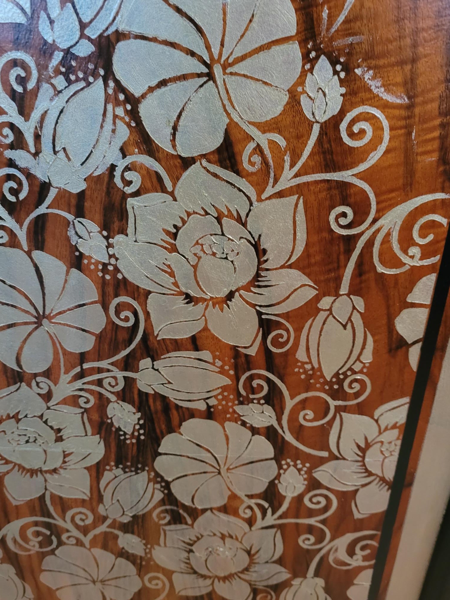 Upcycled Art Deco wardrobe with walnut veneer, black and gold accents, and floral stenciling.