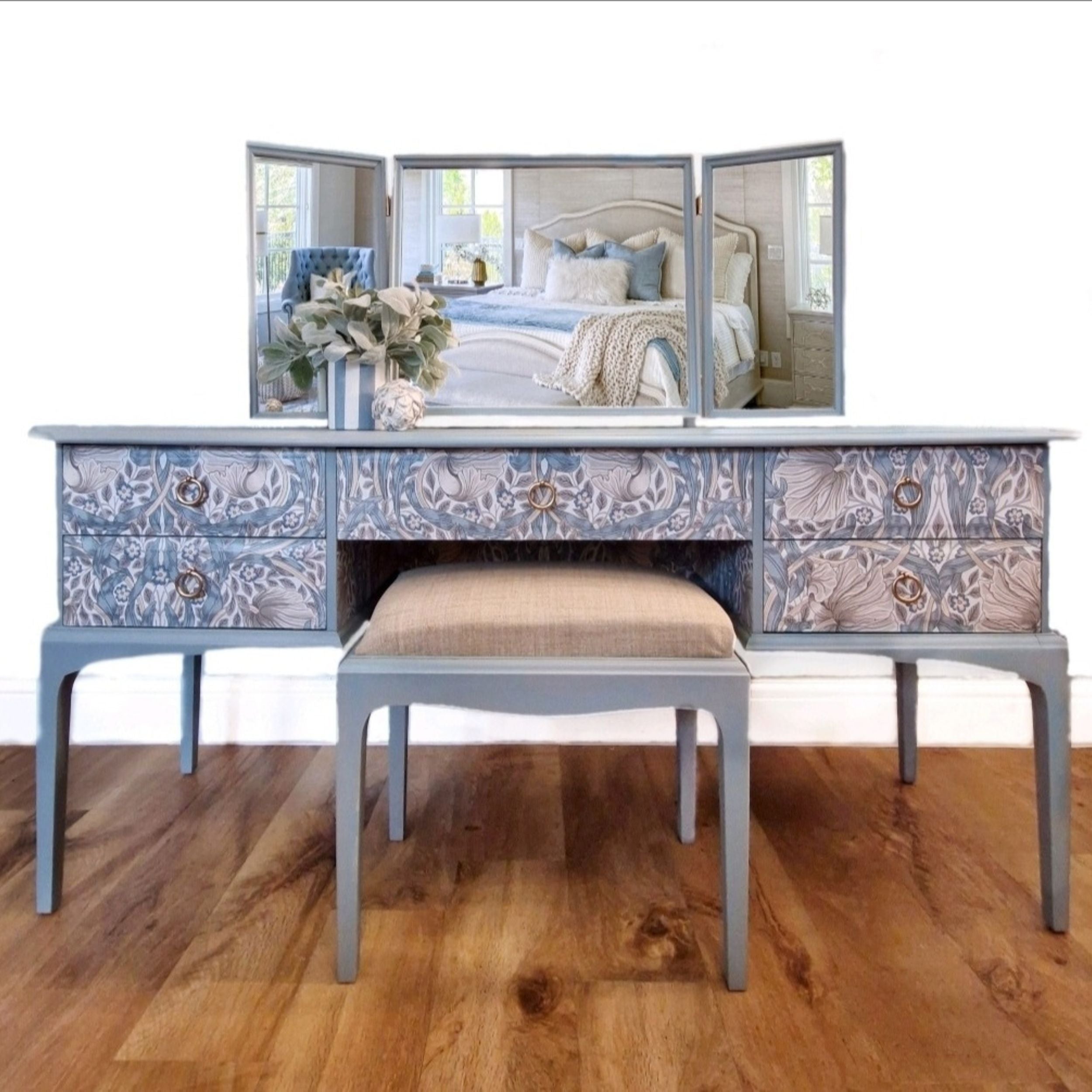 A Stag Minstrel five drawer dressing table painted in Fusion Mineral Paint in colour blue pine and decoupaged in a William Morris wallpaper. The dressing table is complete with triple mirror and upholstered stool.