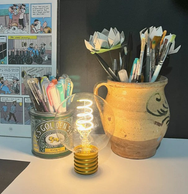 LED bulb shown staged as individual light in a teenagers desk setting