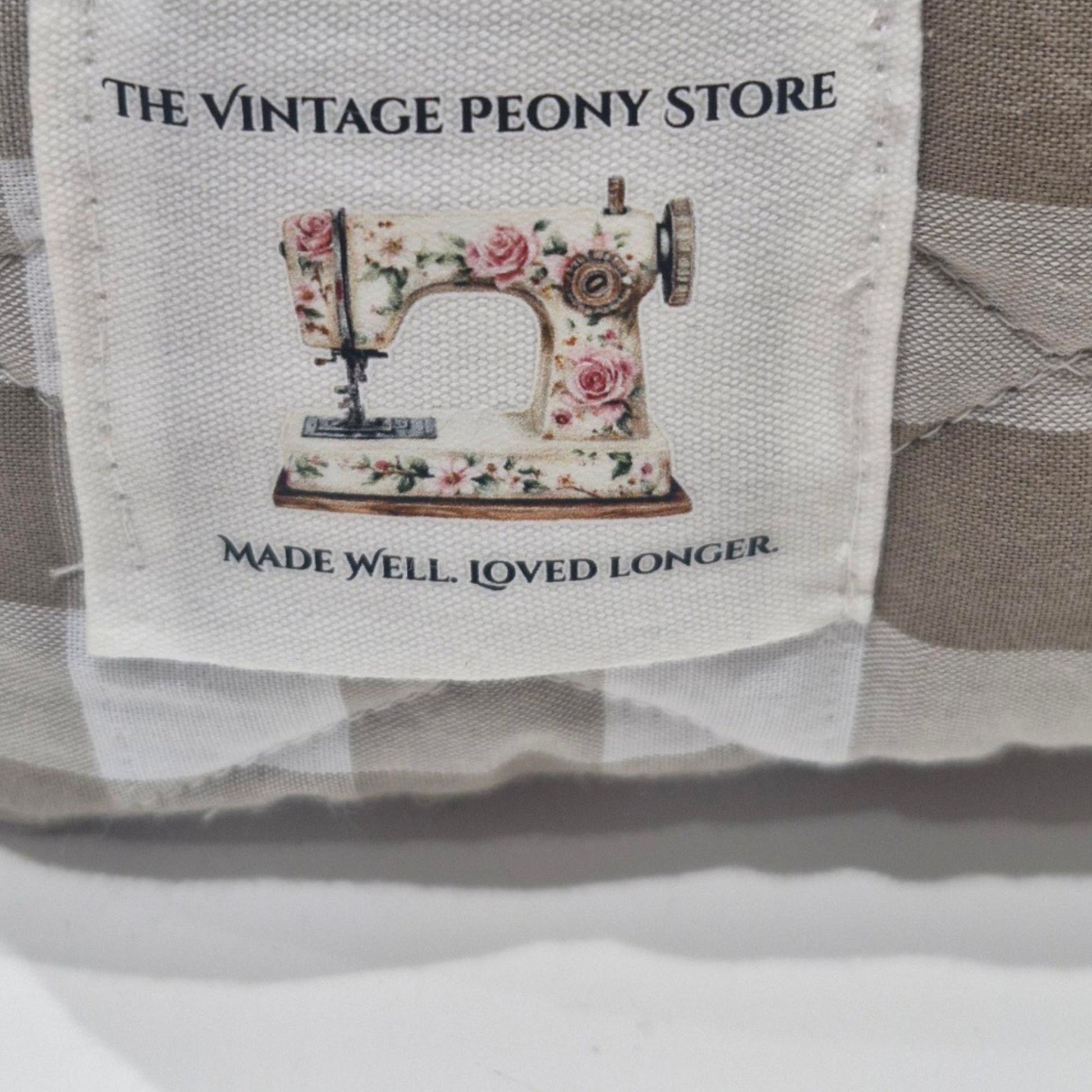 Label with 'The Vintage Peony Store' and sewing machine illustration on a product.