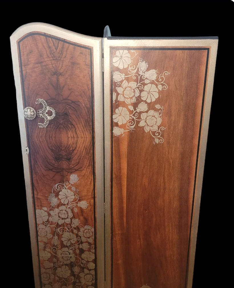 Upcycled Art Deco wardrobe with walnut veneer, black and gold accents, and floral stenciling.