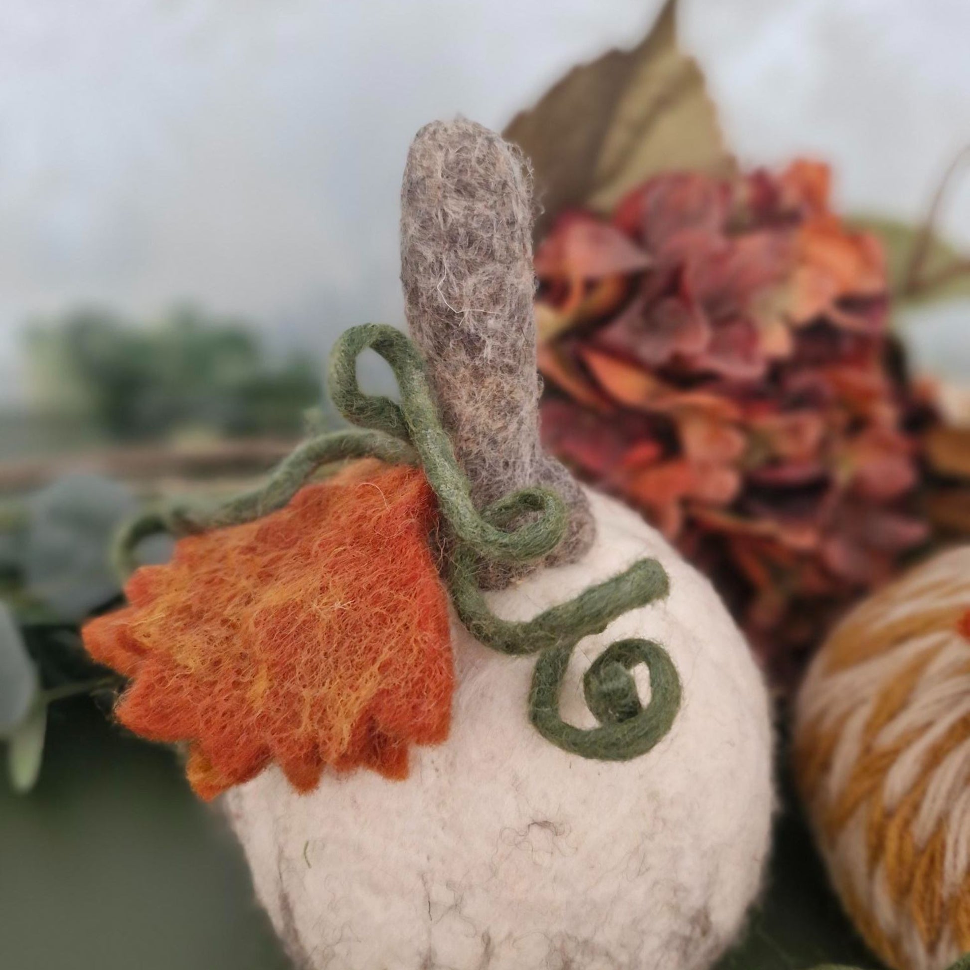 White and grey needle-felted wool pumpkin with leaf and upright stem, 11×11×15cm.
