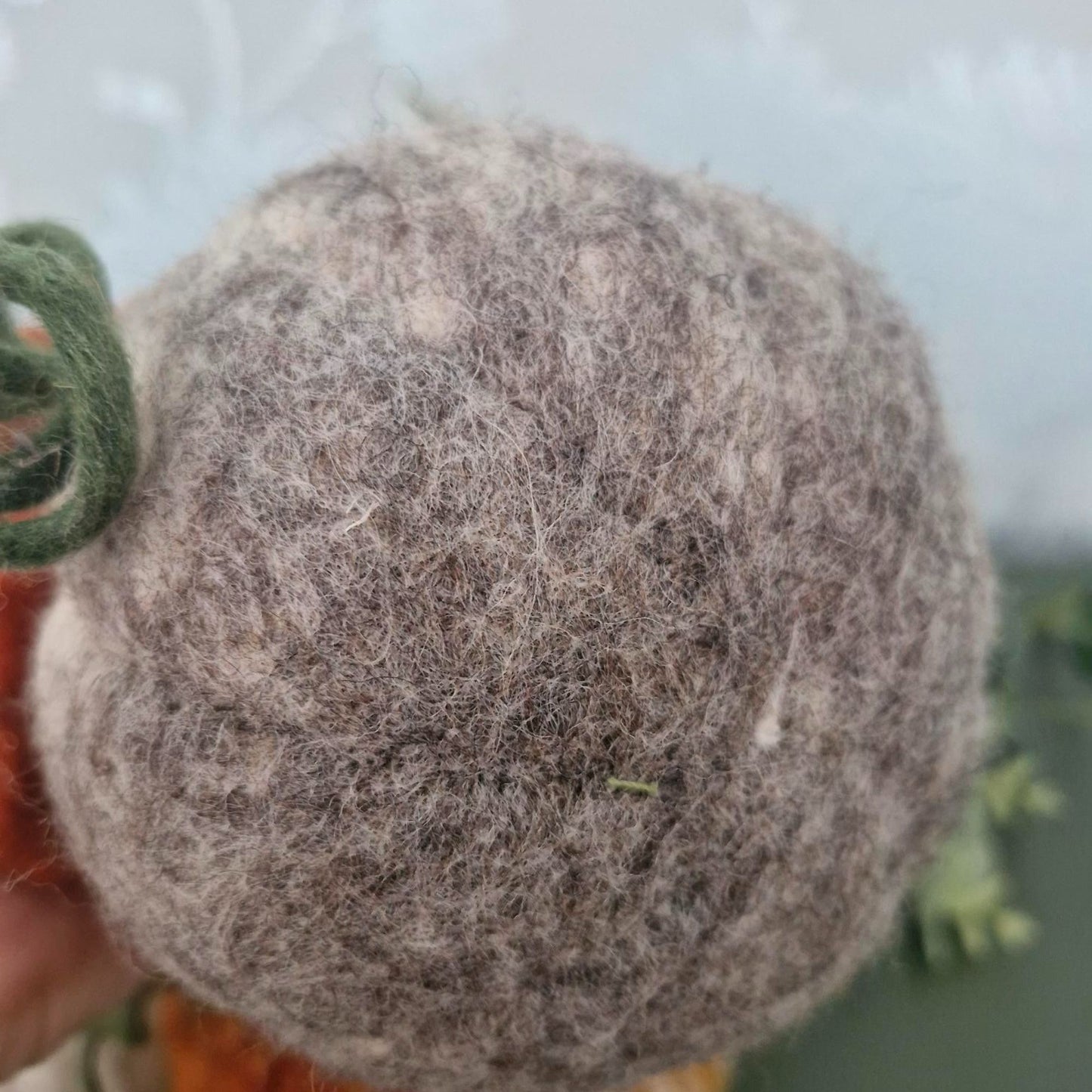 White and grey needle-felted wool pumpkin with leaf and upright stem, 11×11×15cm.