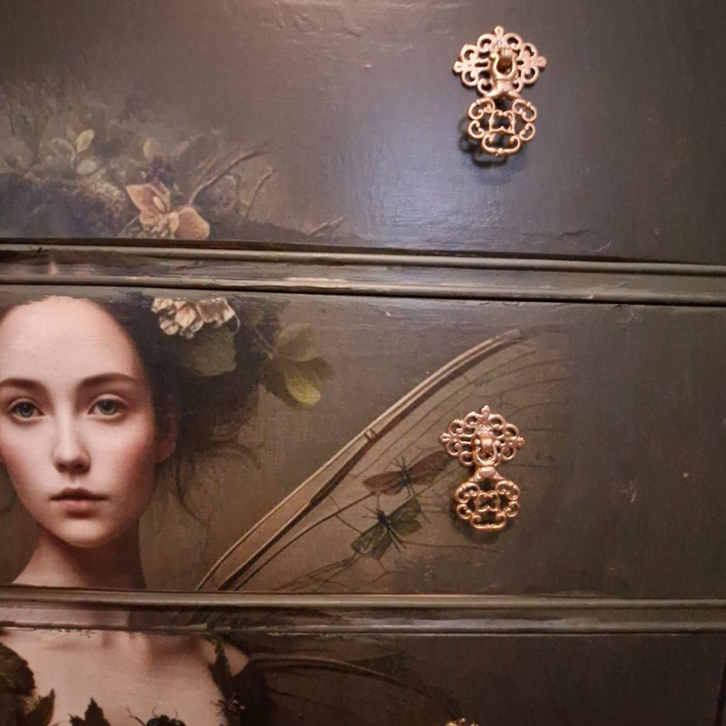 Ethereal fairy decoupage chest in mossy Bayberry with bronze hardware, styled in a calm bedroom setting.