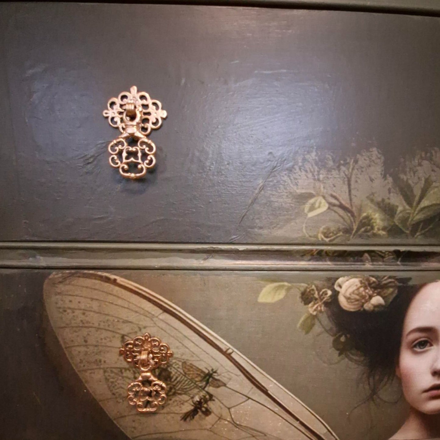 Ethereal fairy decoupage chest in mossy Bayberry with bronze hardware, styled in a calm bedroom setting.