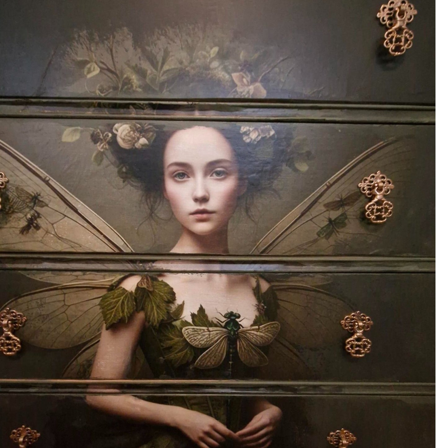 Ethereal fairy decoupage chest in mossy Bayberry with bronze hardware, styled in a calm bedroom setting.