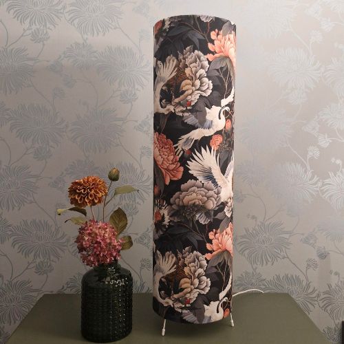 Image shows main floral velvet lampshade next to a green vase with matching flowers