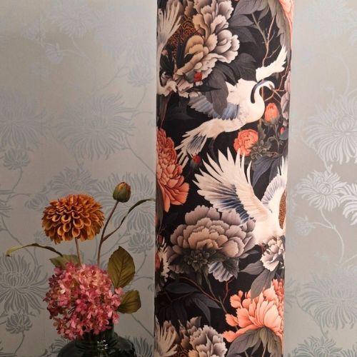 Close up of velvet fabric showing elegant swans and vibrant blooms