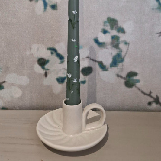 Glazed cream ceramic wee willy winky style candle holder with fluted base and carry handle.