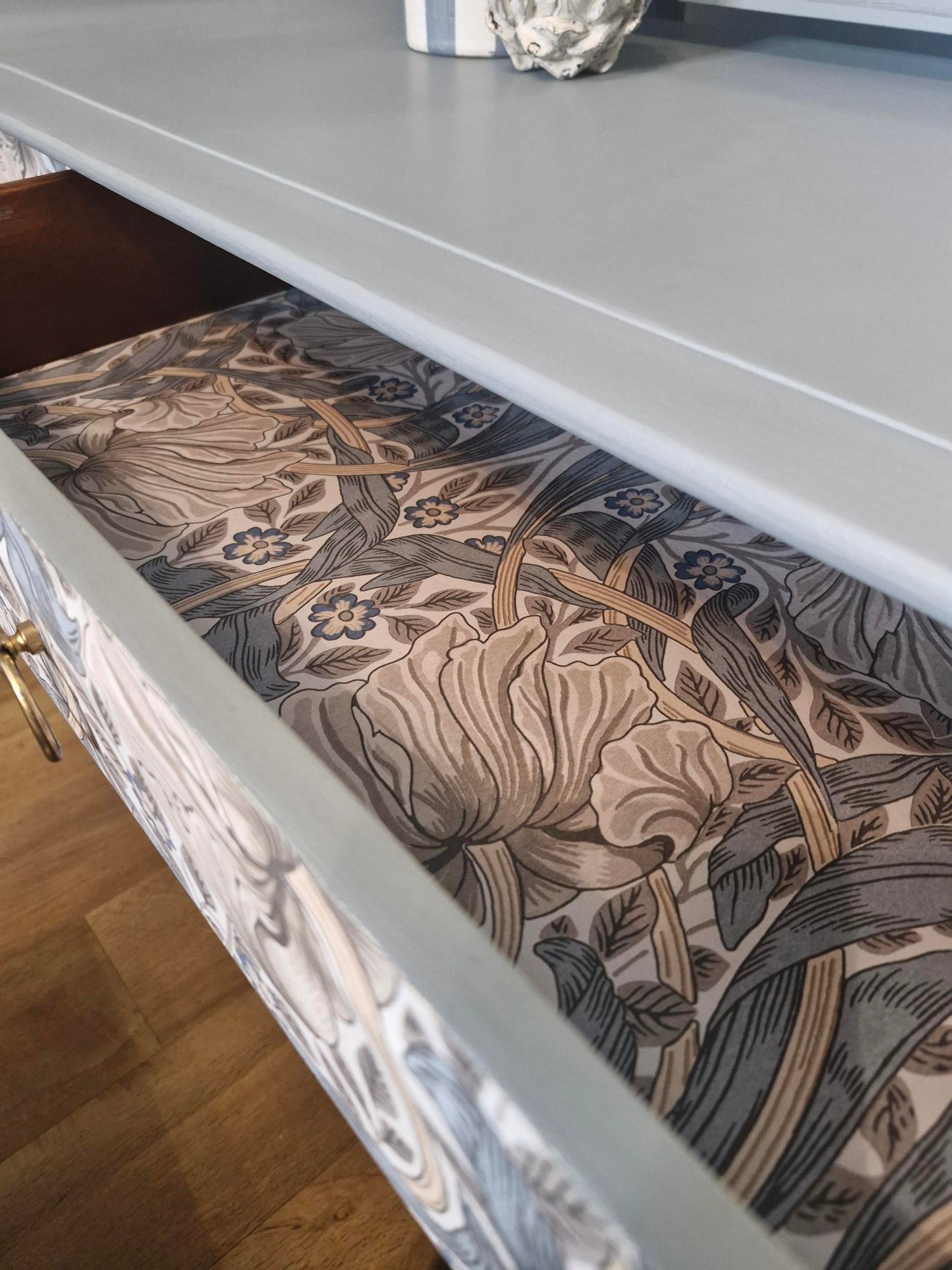 Pull out drawer detail showing William Morris wallpaper decoupage detail