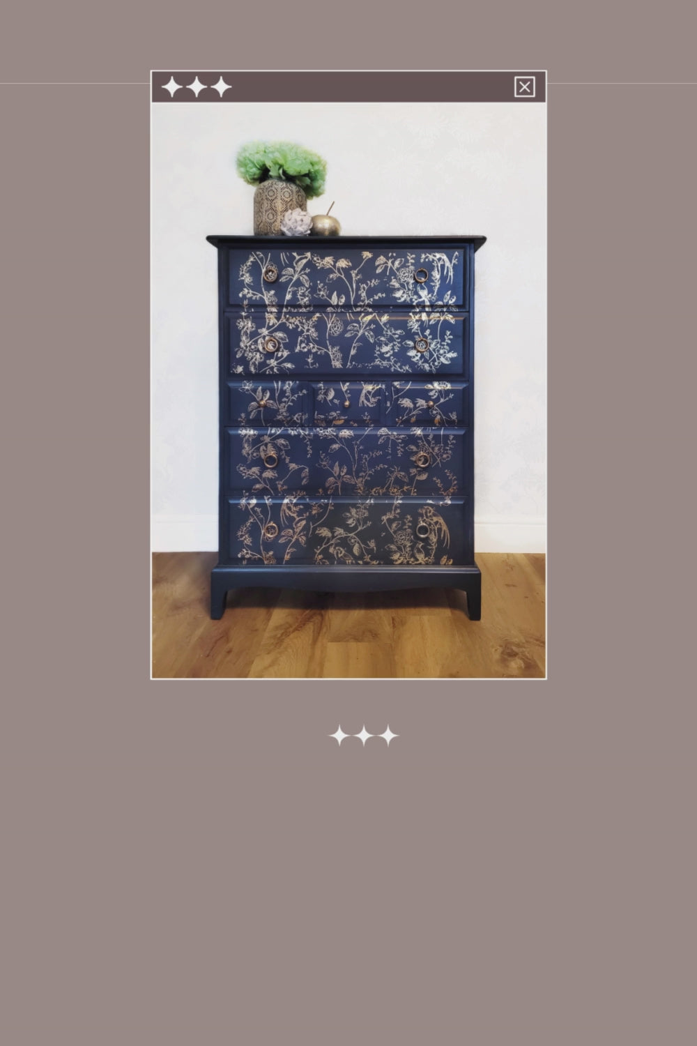 Elegant upcycled navy blue chest of drawers featuring a delicate, hand-painted gold floral design. The drawers are accented with intricate gold knobs, making this piece a sophisticated addition to any living room, bedroom, or hallway.